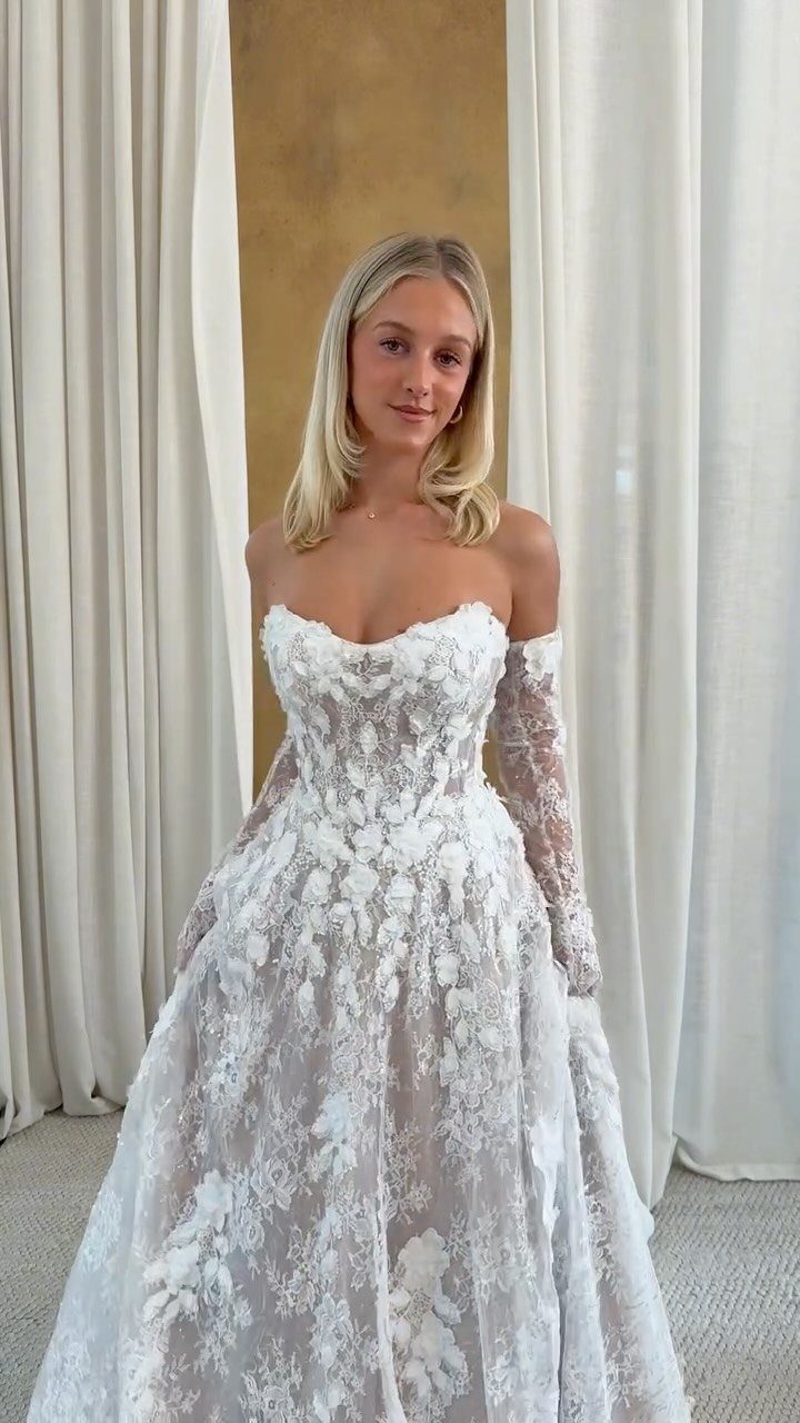Basque Waist Wedding Dress Lace Ideas: 5 Styles 3 Woman in a white floral lace wedding dress with long lace sleeves.
