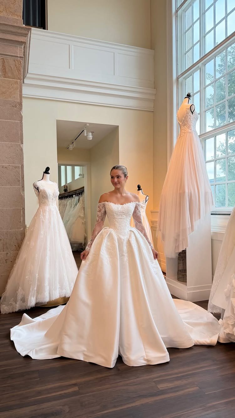 Basque Waist Wedding Dress Lace Ideas: 5 Styles 4 Woman wearing a white basque waist wedding dress with lace sleeves in a salon.