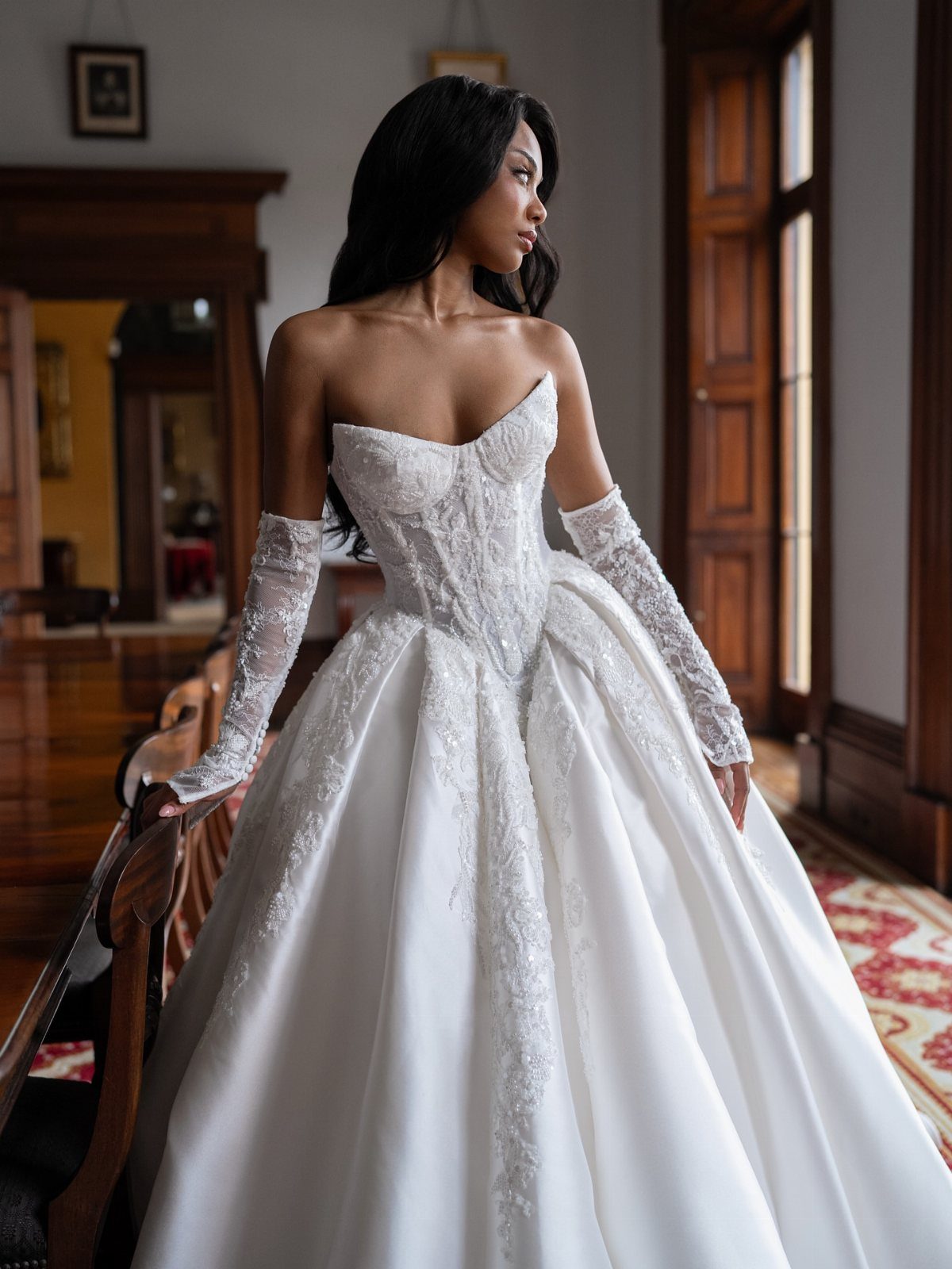 Basque Waist Wedding Dress Lace Ideas: 5 Styles 1 Woman in a white wedding dress with a structured basque waist and lace gloves.