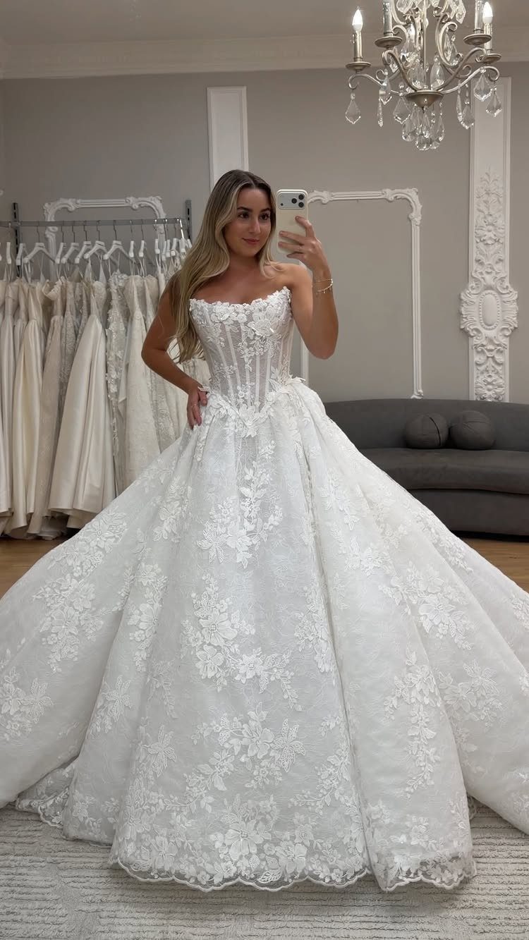 6 Basque Wedding Dress Ideas, from Lace to Ball Gowns 1 Woman wearing a white strapless Basque waist wedding dress with a full lace skirt.