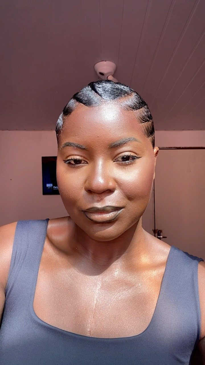 11 Black Natural Hair Wedding Hairstyles for Brides 2 Black woman with short hair styled in glossy, sculpted vintage finger waves.