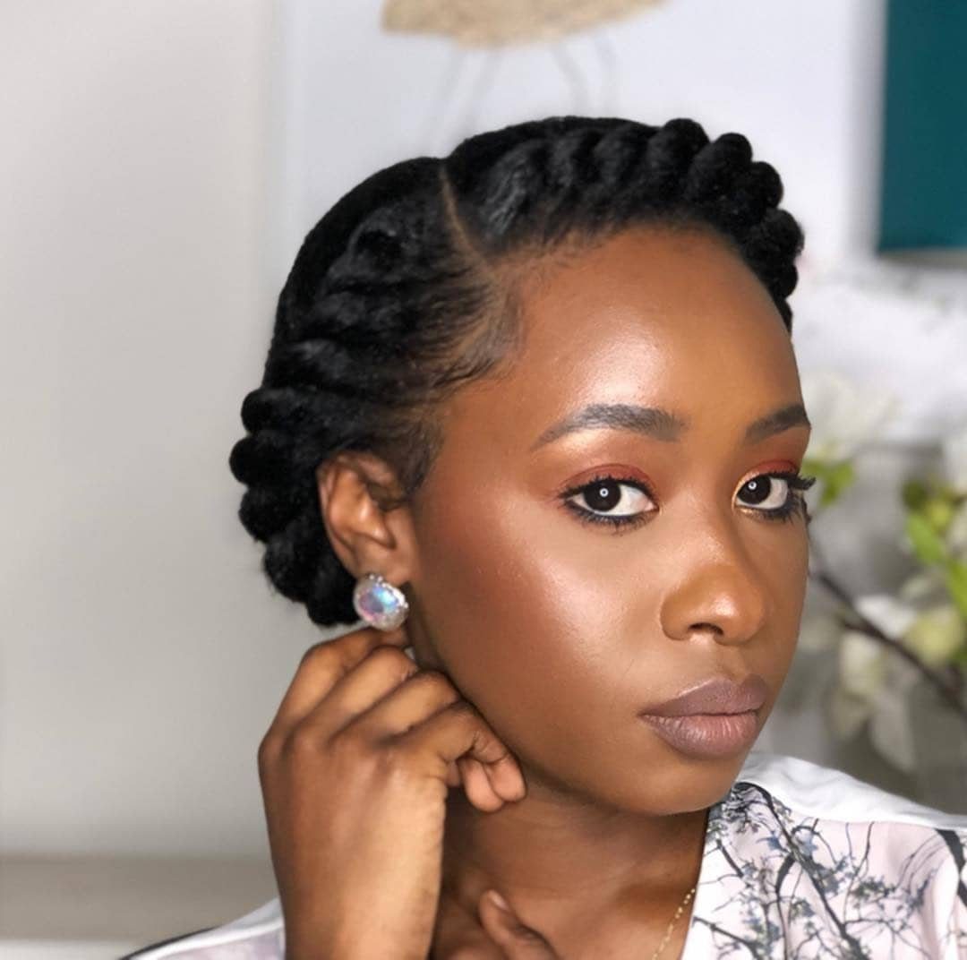 11 Black Natural Hair Wedding Hairstyles for Brides 1 Black woman with a twisted crown braid hairstyle and warm-toned makeup.