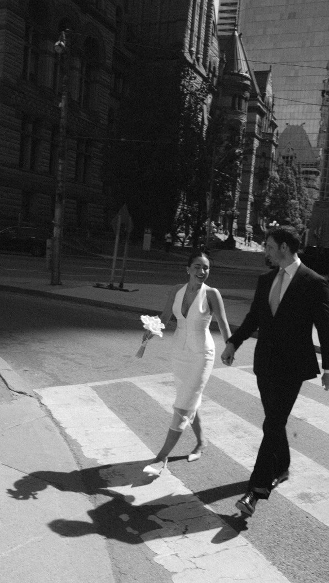 City Hall Wedding Ideas: 7 Ways to Plan the Day 4 Newlywed couple walking across a city street in formal wedding attire.