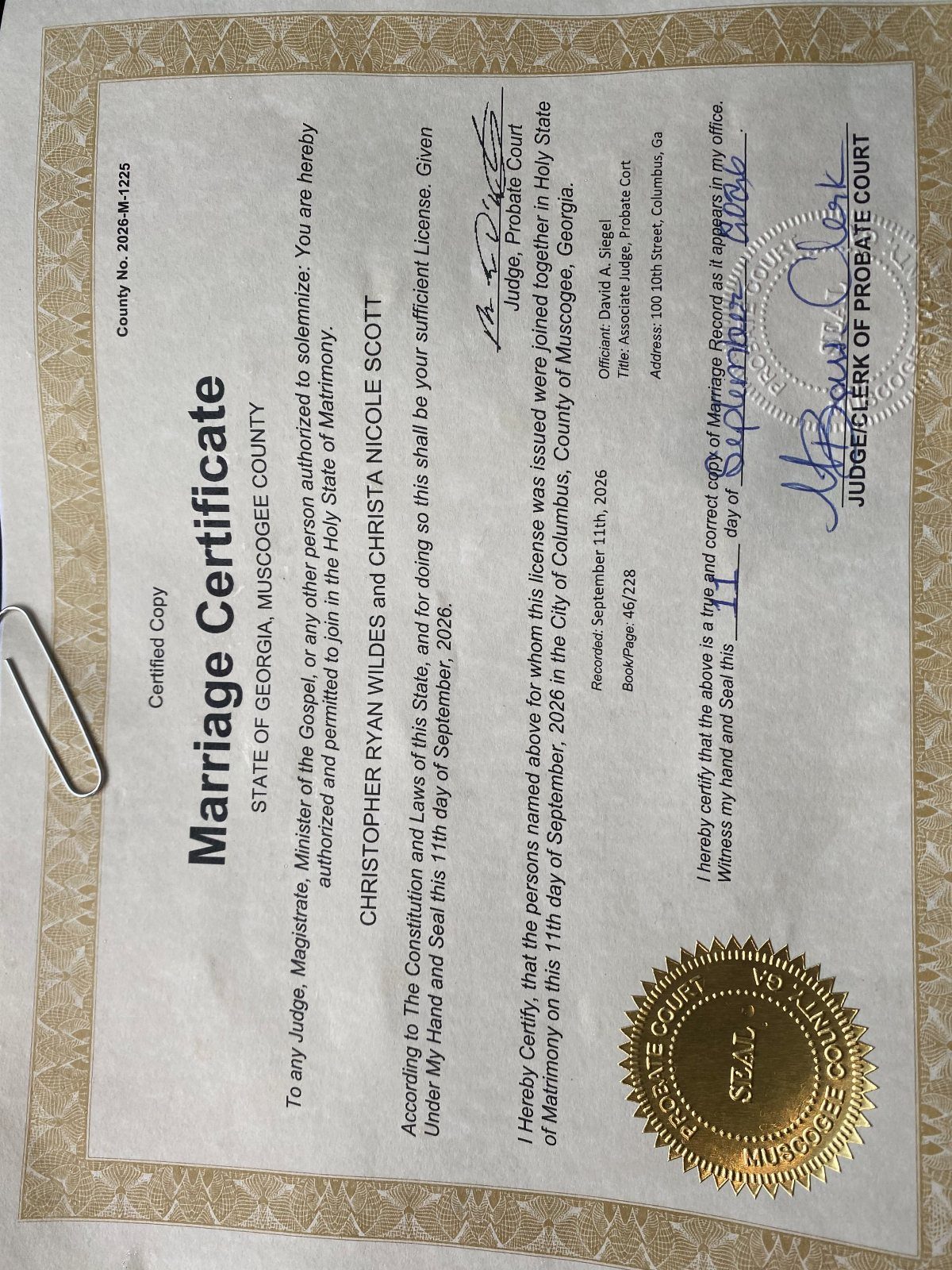 City Hall Wedding Ideas: 7 Ways to Plan the Day 6 Marriage certificate certified copy with a gold embossed seal and silver paperclip.