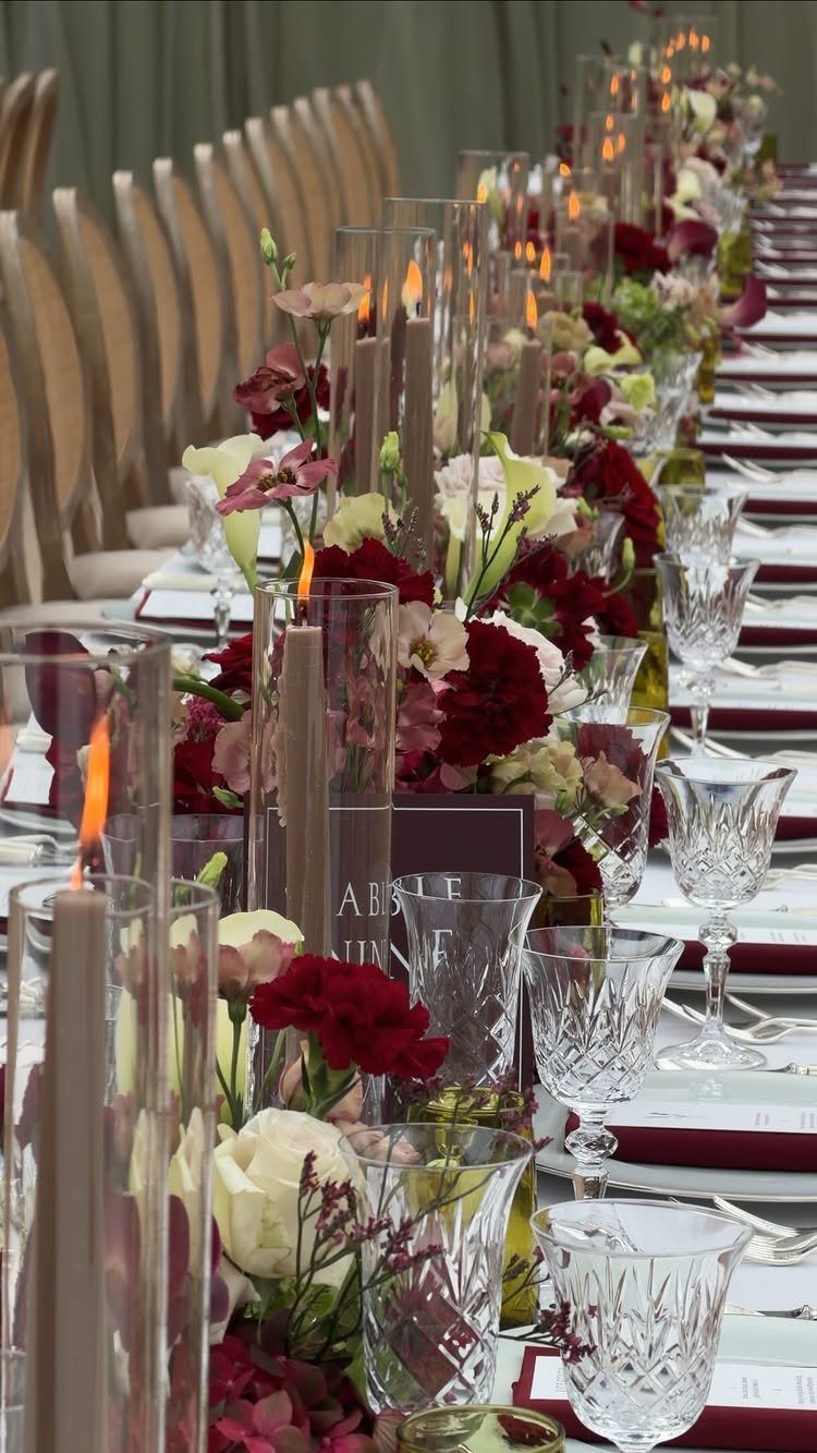 Colour Scheme for Wedding: 15 Ideas and Palettes 13 Wedding table setting with burgundy and cream flowers, crystal glasses, and tall candles.