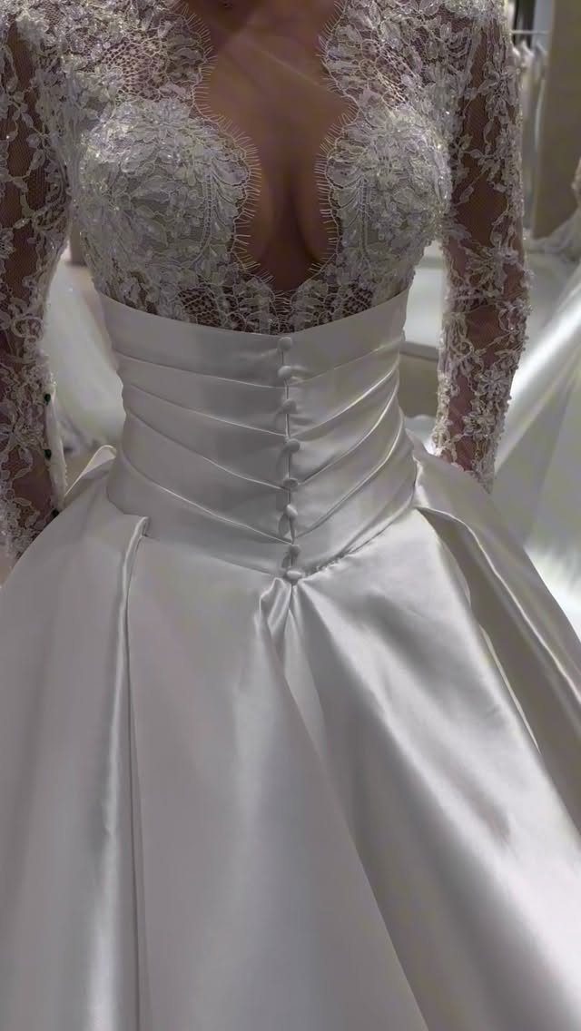 Corset Style Wedding Dress Ideas: 8 Designs to Love 5 White wedding dress with lace bodice and satin corset waist with buttons.