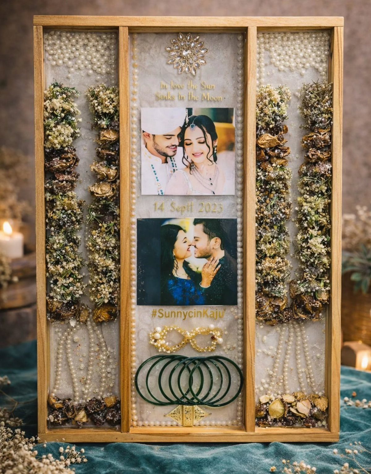 Wooden shadow box with wedding photos, jewelry, and dried floral decorations.