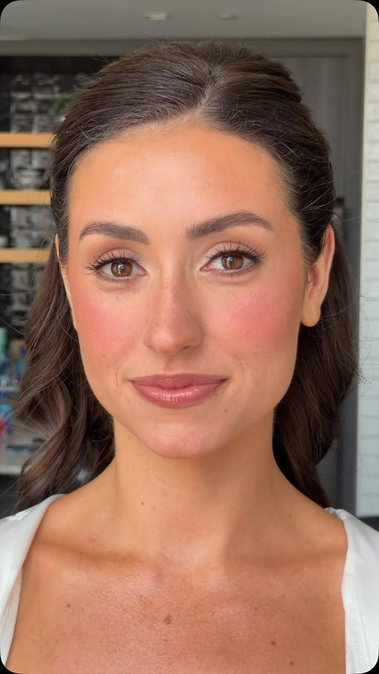 Woman with natural wedding makeup, soft brown eyeshadow, and nude-pink lipstick.