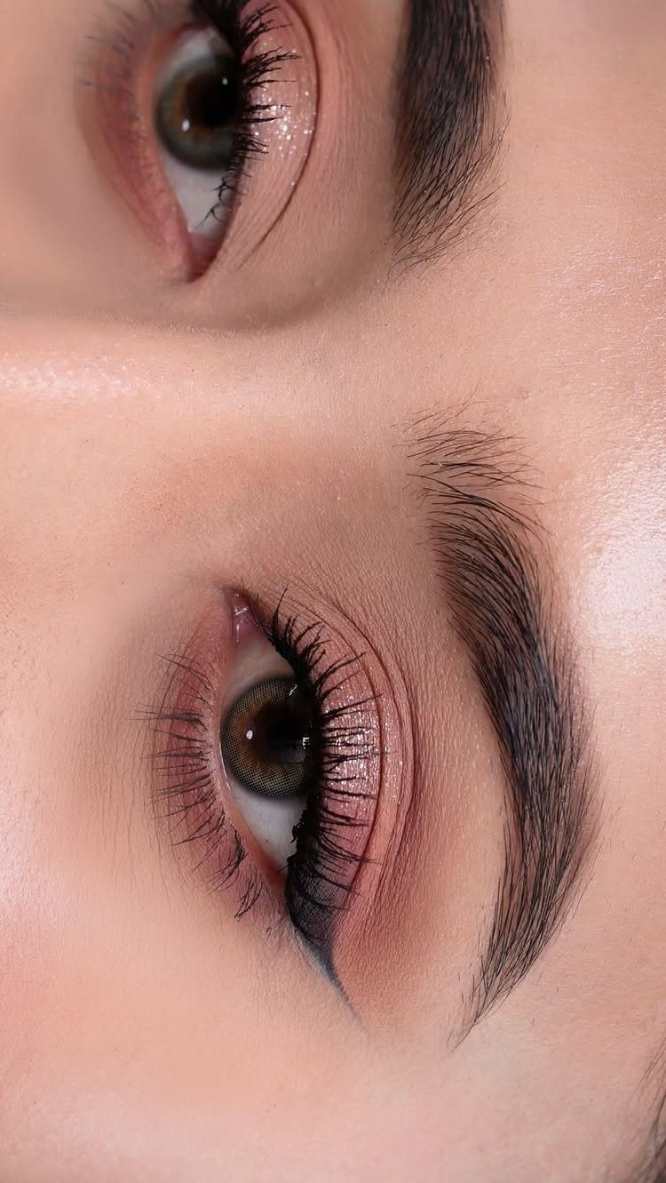 Close-up of eyes with shimmering pink and rose-gold eyeshadow and long lashes.