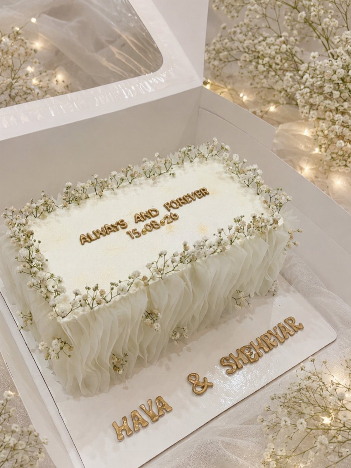 Flat Wedding Cakes: 6 Ideas for Simple, Low Tiers 2 Rectangular white wedding cake decorated with baby's breath flowers and gold lettering.