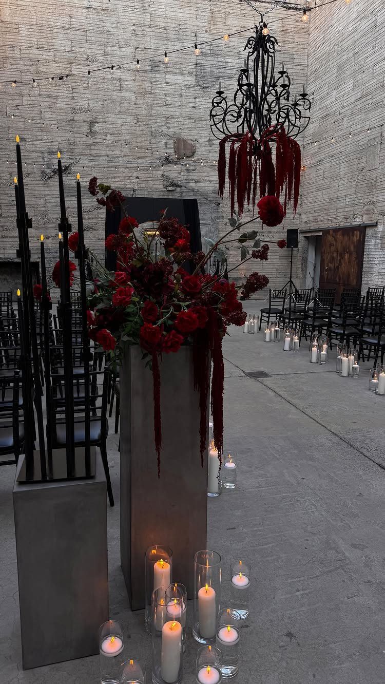 8 Gothic Romance Wedding Ideas for a Dark, Moody Day 3 Gothic wedding decor with red roses, black taper candles, and white pillar candles.