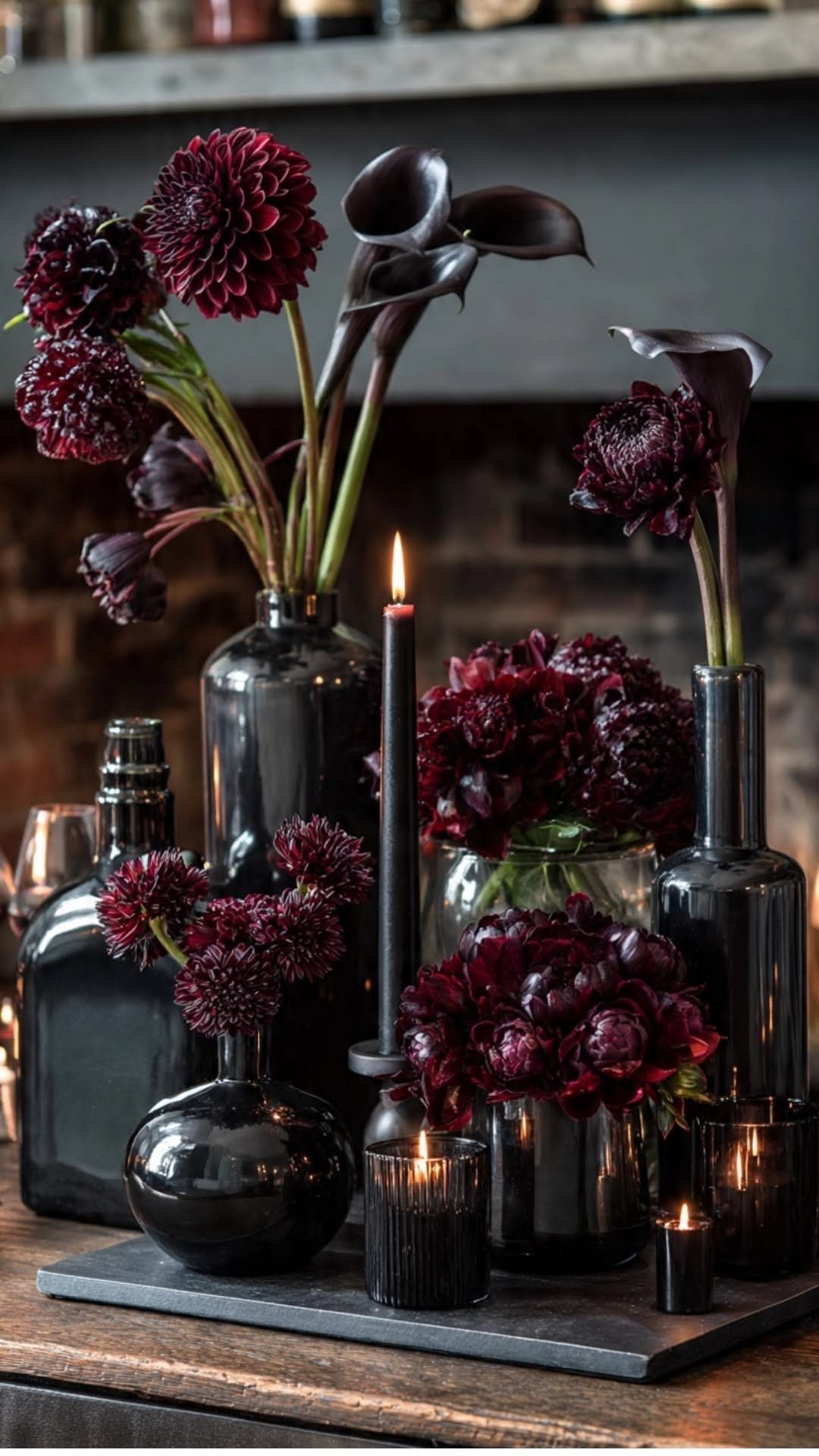 8 Gothic Romance Wedding Ideas for a Dark, Moody Day 5 Deep burgundy dahlias and black calla lilies in black vases with black candles.