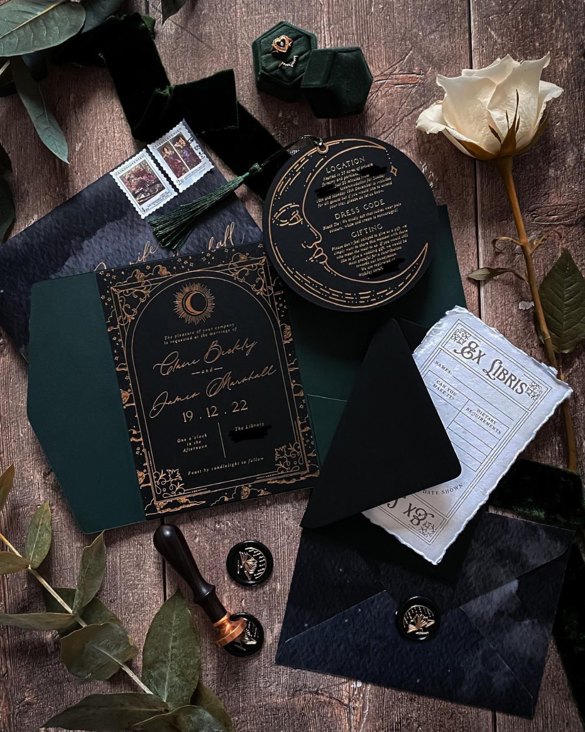 8 Gothic Romance Wedding Ideas for a Dark, Moody Day 2 Gothic wedding stationery set with black and green envelopes, gold calligraphy, and white rose.