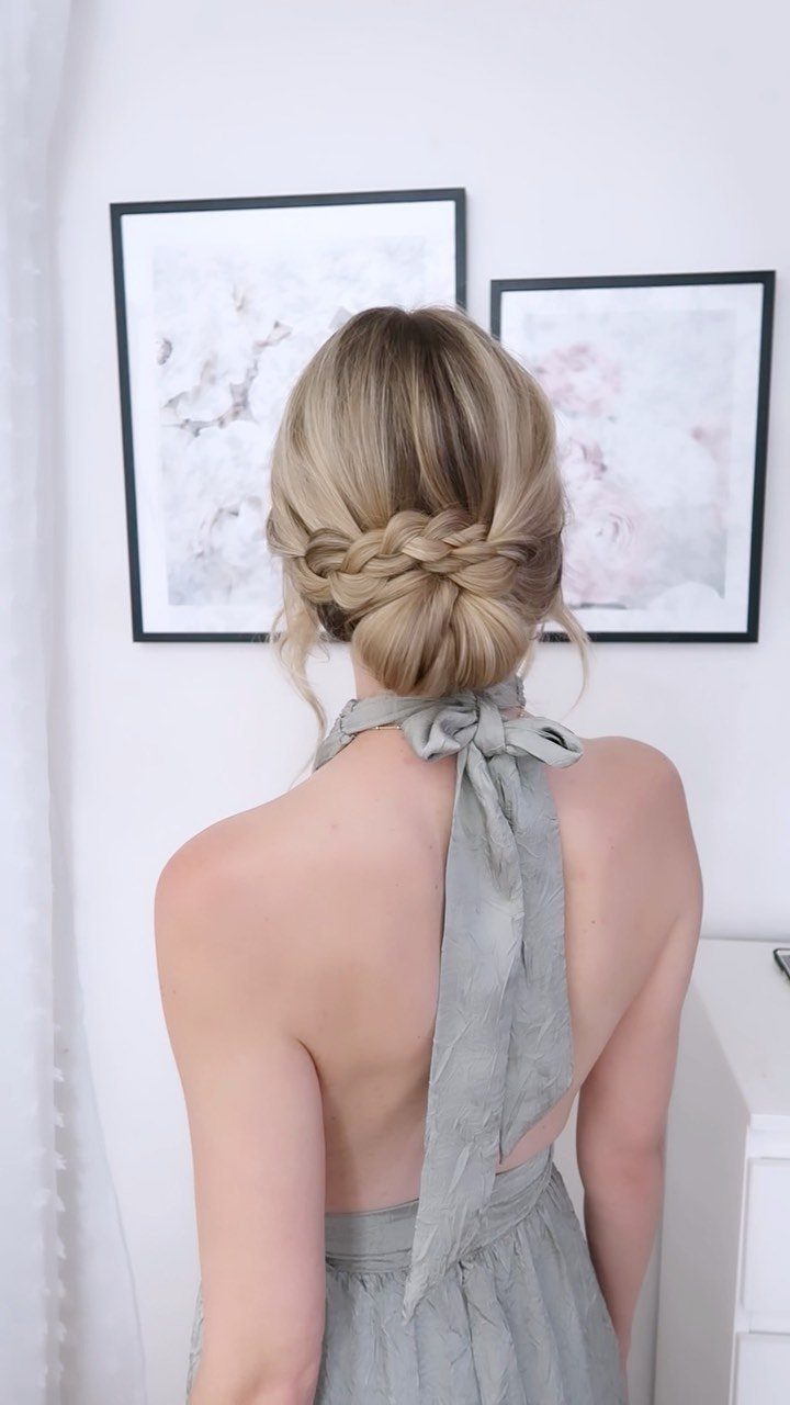 14 Ideas for Hair for a Wedding Guest, From Buns to Waves 4 Blonde hair styled in a low braided chignon bun with a grey dress.