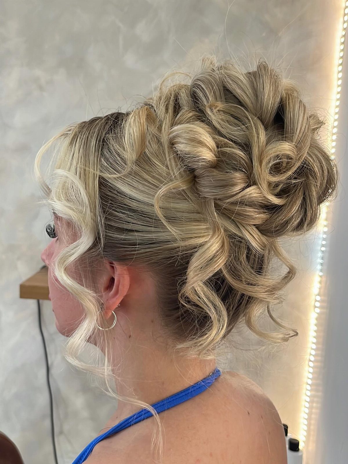 14 Ideas for Hair for a Wedding Guest, From Buns to Waves 5 Blonde curly updo with voluminous ringlets and loose face-framing curls.