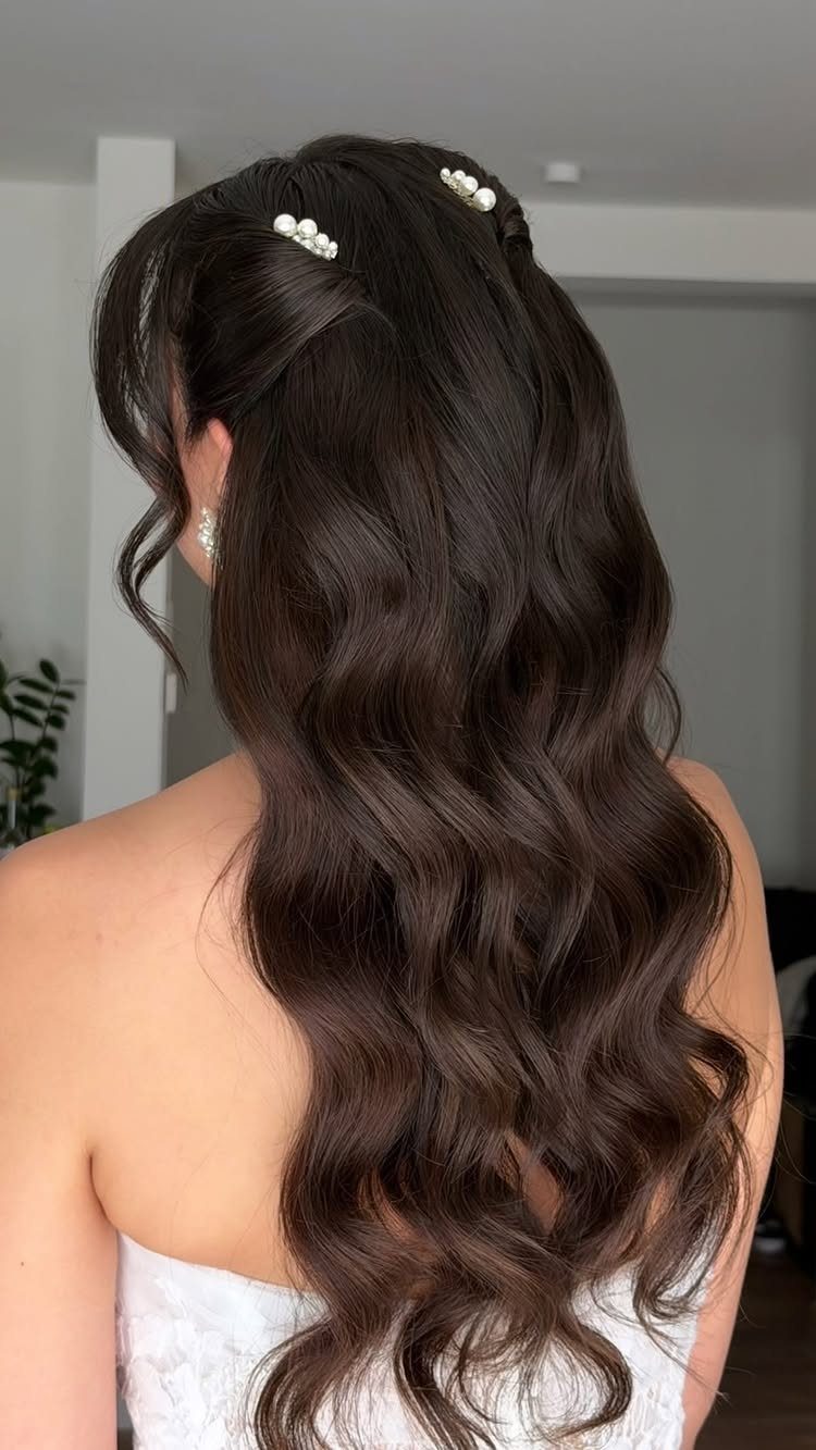 11 Half Up and Down Wedding Hair Ideas for Brides 8 Dark brown wavy hair in a half-up style with pearl clips and white dress