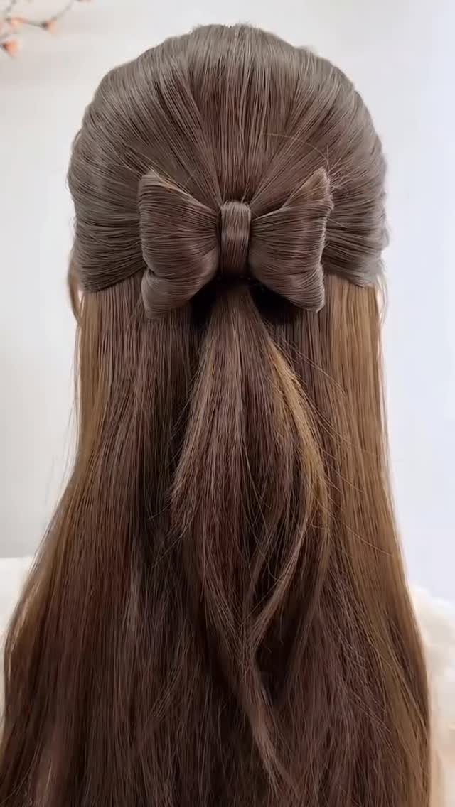 11 Half Up and Down Wedding Hair Ideas for Brides 9 Long brown hair styled in a half-updo with a large hair bow.