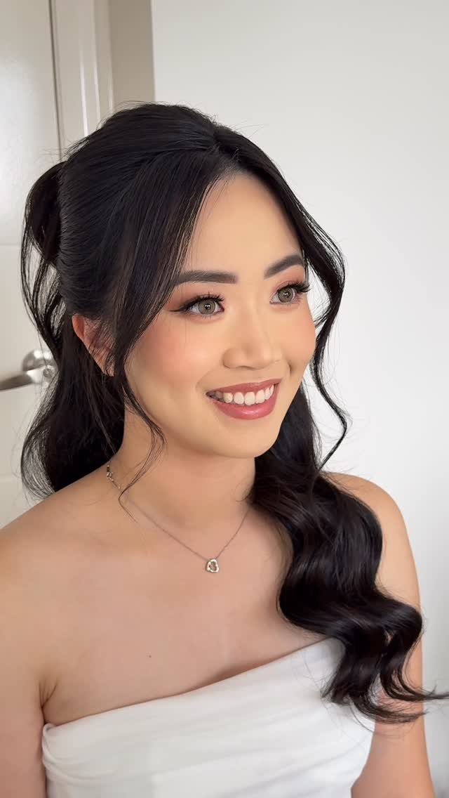 11 Half Up and Down Wedding Hair Ideas for Brides 6 Woman with black hair in a half-up style with sleek Hollywood waves