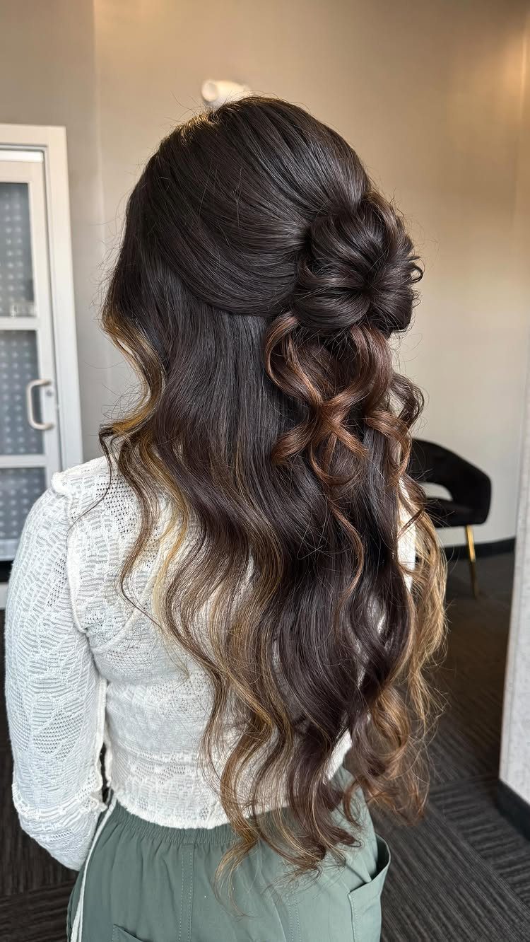 11 Half Up and Down Wedding Hair Ideas for Brides 2 Woman with long brunette hair in a soft, tousled half-up half-down curly hairstyle.