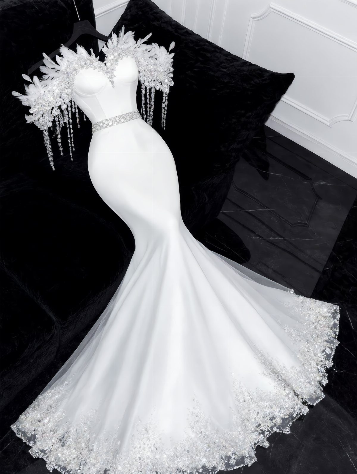 White mermaid wedding dress with ornate beading on the shoulders and hem.