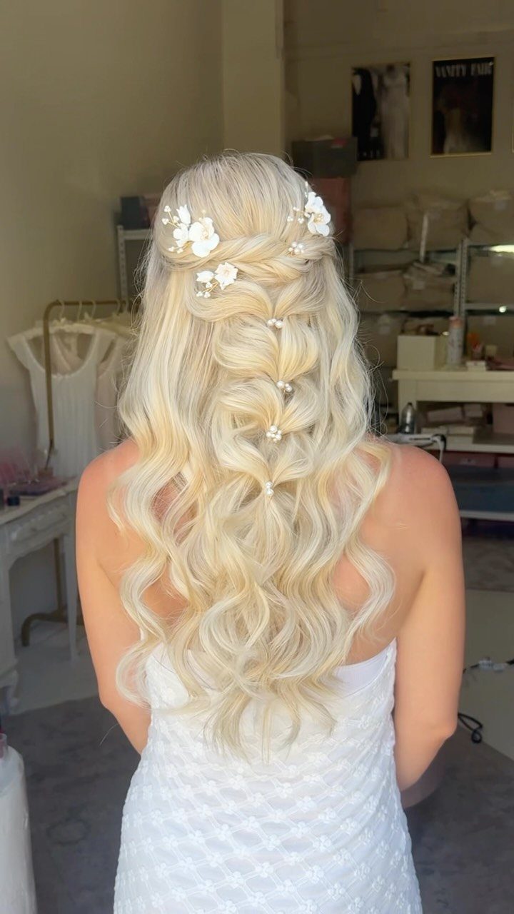 15 Long Hair Wedding Styles for Braids, Buns and Waves 1 Long blonde wavy hair in a braided half-up style with white floral accents