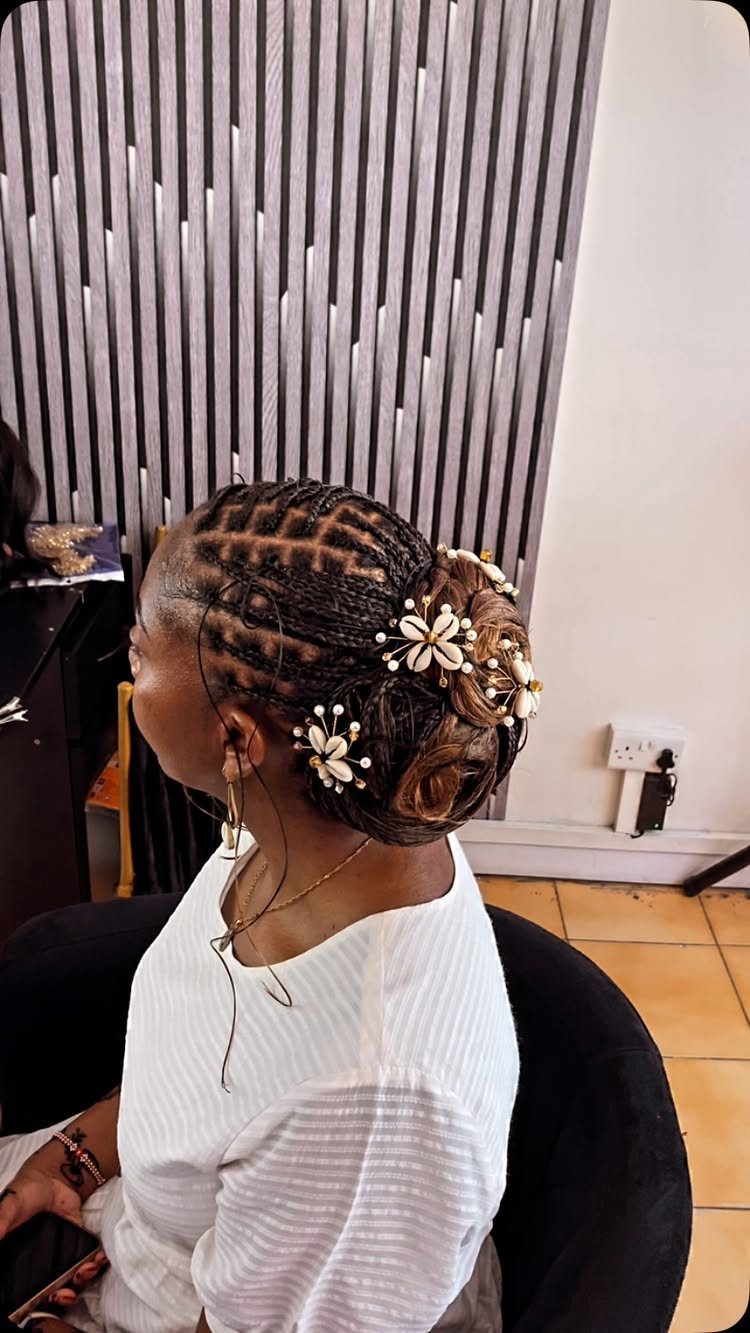15 Long Hair Wedding Styles for Braids, Buns and Waves 15 Woman with braided long hair in a low bun with white floral accessories