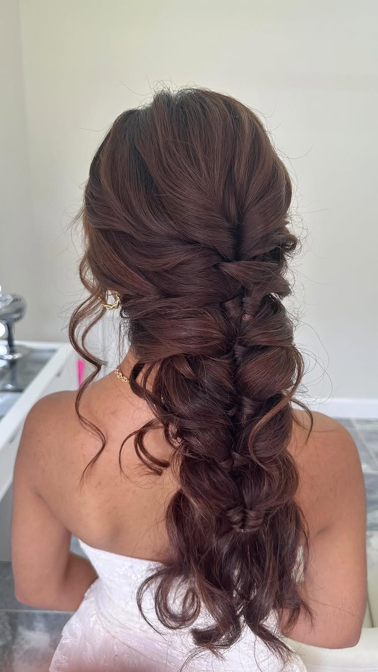 15 Long Hair Wedding Styles for Braids, Buns and Waves 8 Long auburn hair styled in a loose, voluminous bridal braid cascading down the back.