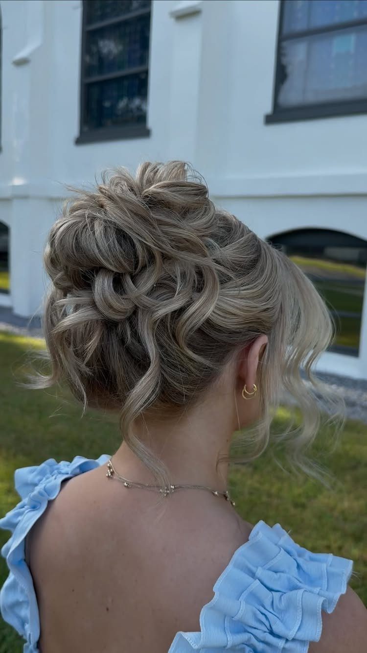 15 Long Hair Wedding Styles for Braids, Buns and Waves 4 Blonde woman with a romantic messy updo and light blue ruffled dress.