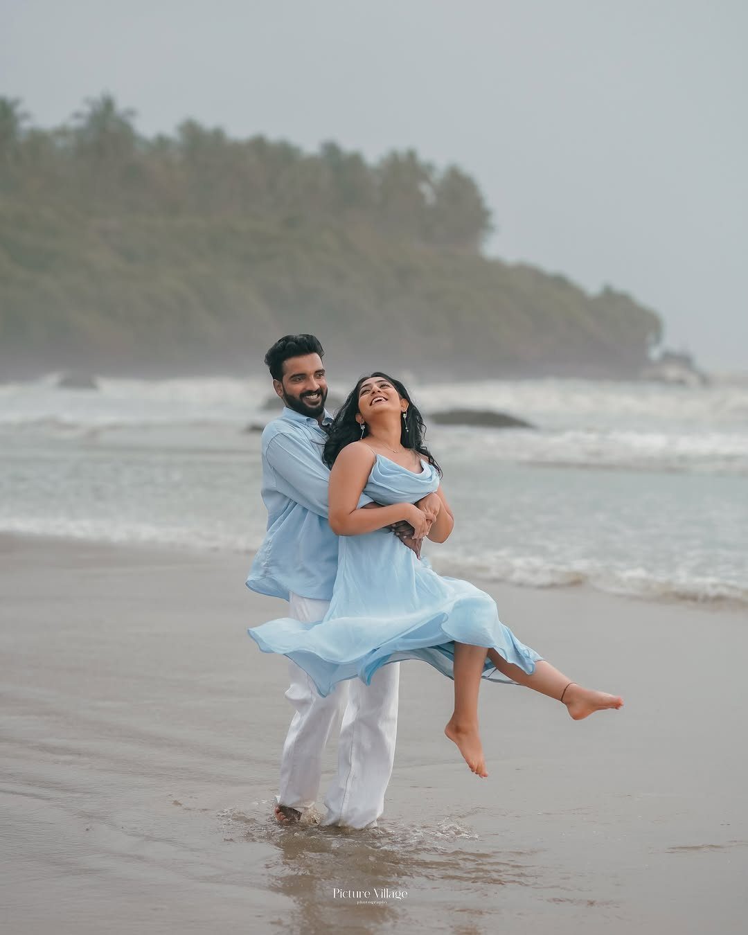 12 Pre Wedding Photoshoot Outfit Ideas for Couples 12 Couple in coordinating light blue outfits embracing on a misty beach shoreline