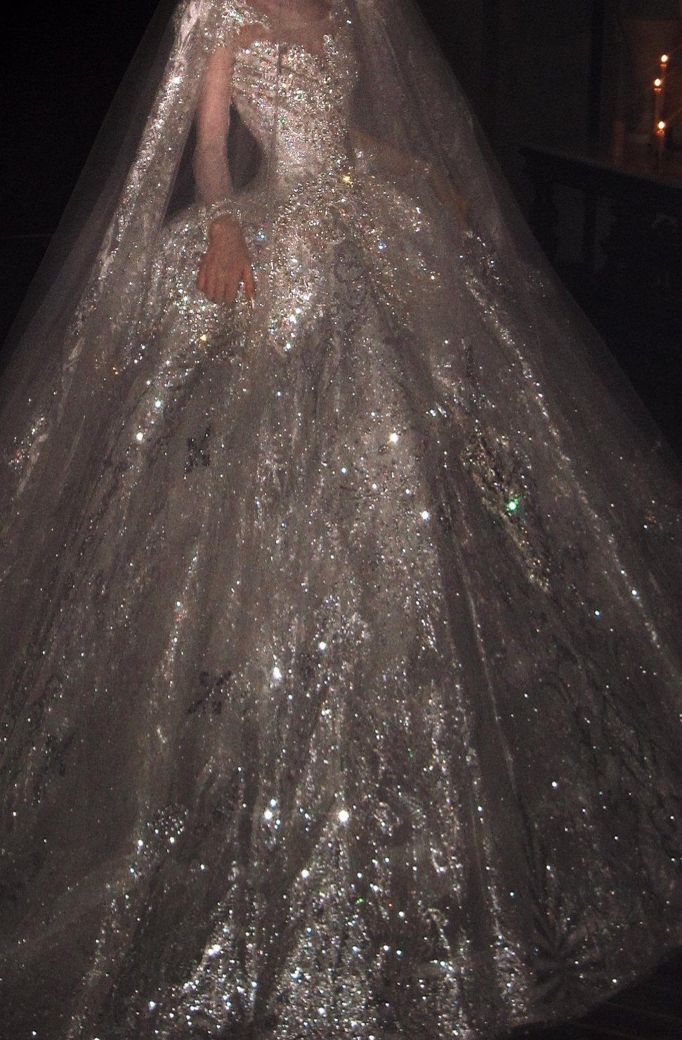 Sparkling silver ballgown wedding dress with a full skirt and sheer veil.