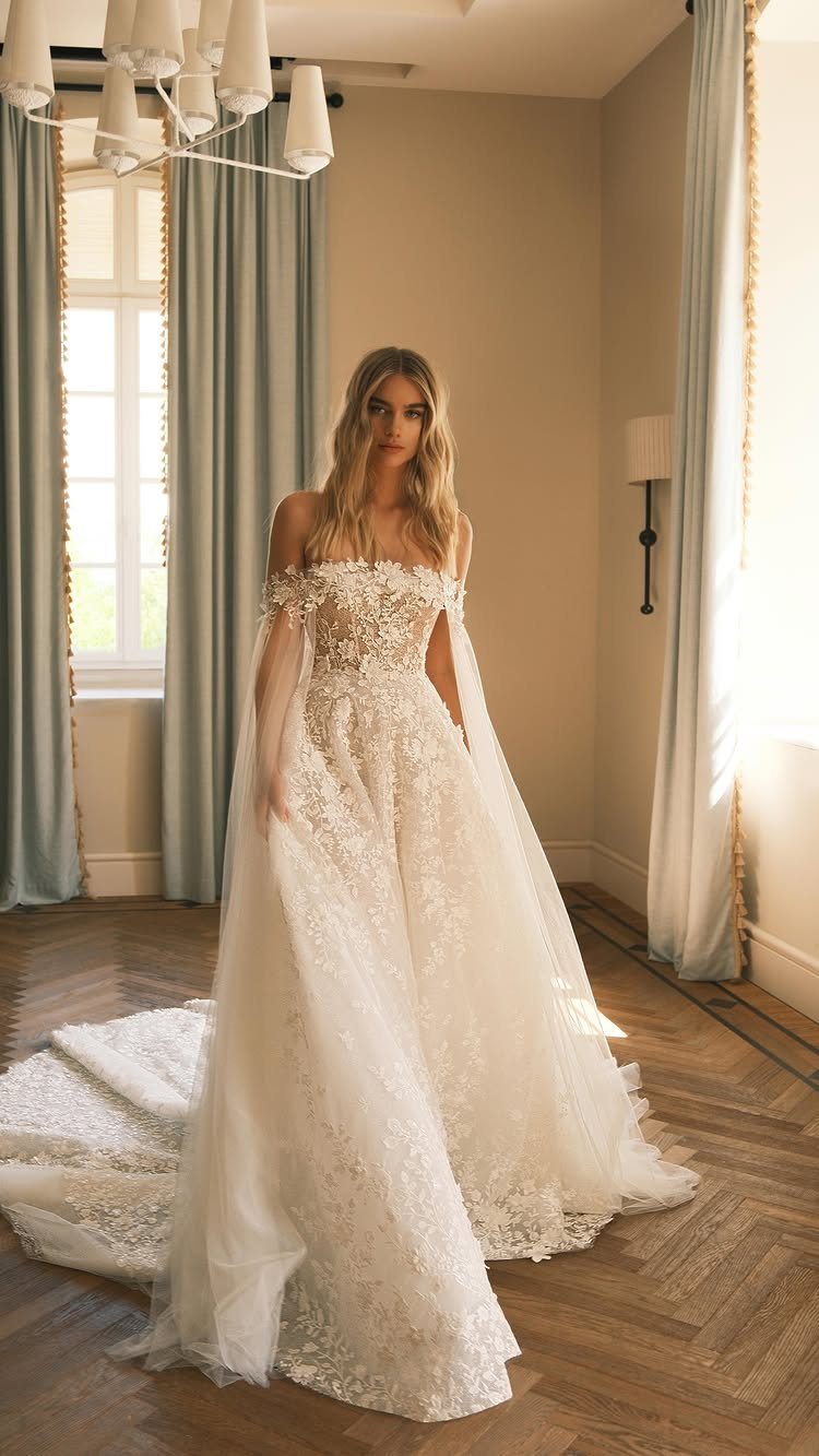 Woman in a white lace wedding dress with a sweetheart neckline and full skirt.