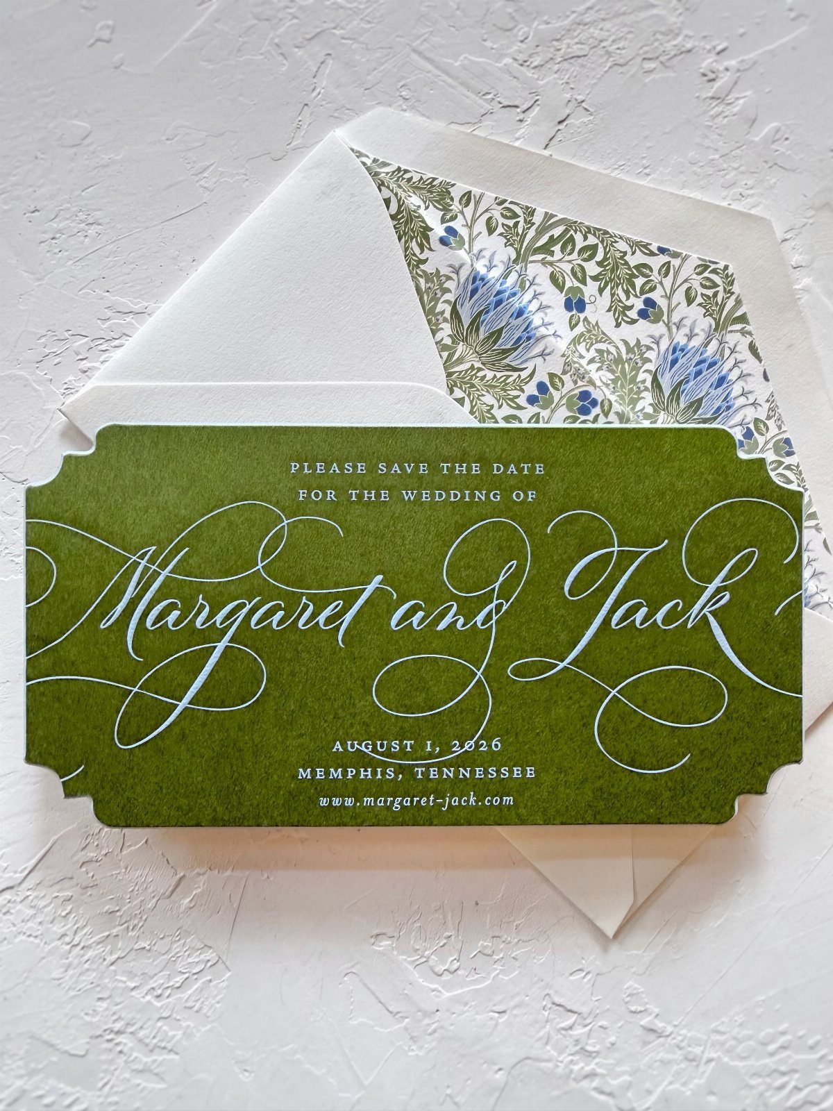 Save the Date Wedding Invite Ideas: 11 Styles to Try 2 Green save the date card with white script text and floral lined envelope.