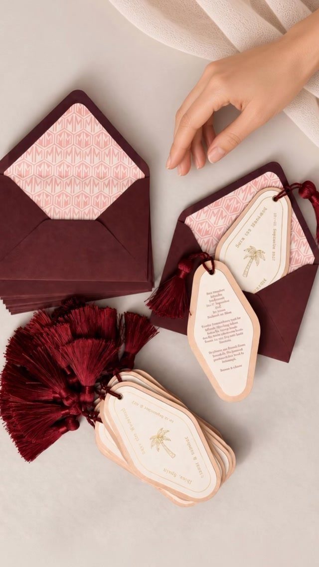 Save the Date Wedding Invite Ideas: 11 Styles to Try 11 Burgundy envelopes and white gold-foiled wedding invitations with decorative burgundy tassels.
