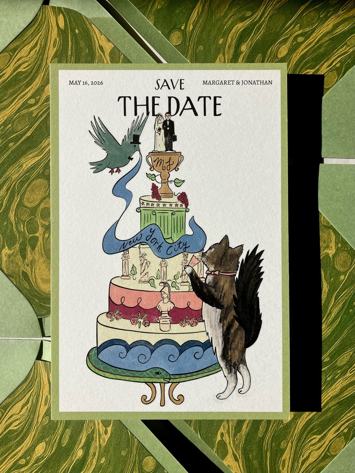 Save the Date Wedding Invite Ideas: 11 Styles to Try 5 Illustrated save the date card with a cat and bird around a wedding cake.