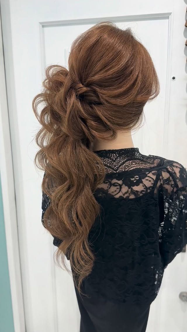 6 Side Ponytail Wedding Hairstyles for Every Bridal Look 4 Auburn hair styled in a voluminous side ponytail with curls and a black lace top.
