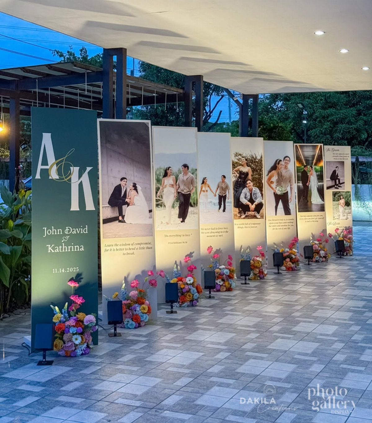 Personalized wedding photo backdrop panels with couple's photos and names on a tiled patio.
