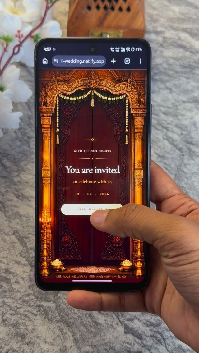 Smartphone screen displaying an ornate red and gold digital wedding invitation.