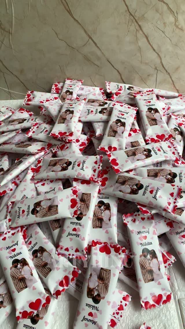 Custom candy wrappers with a couple's photo and red hearts for a wedding.