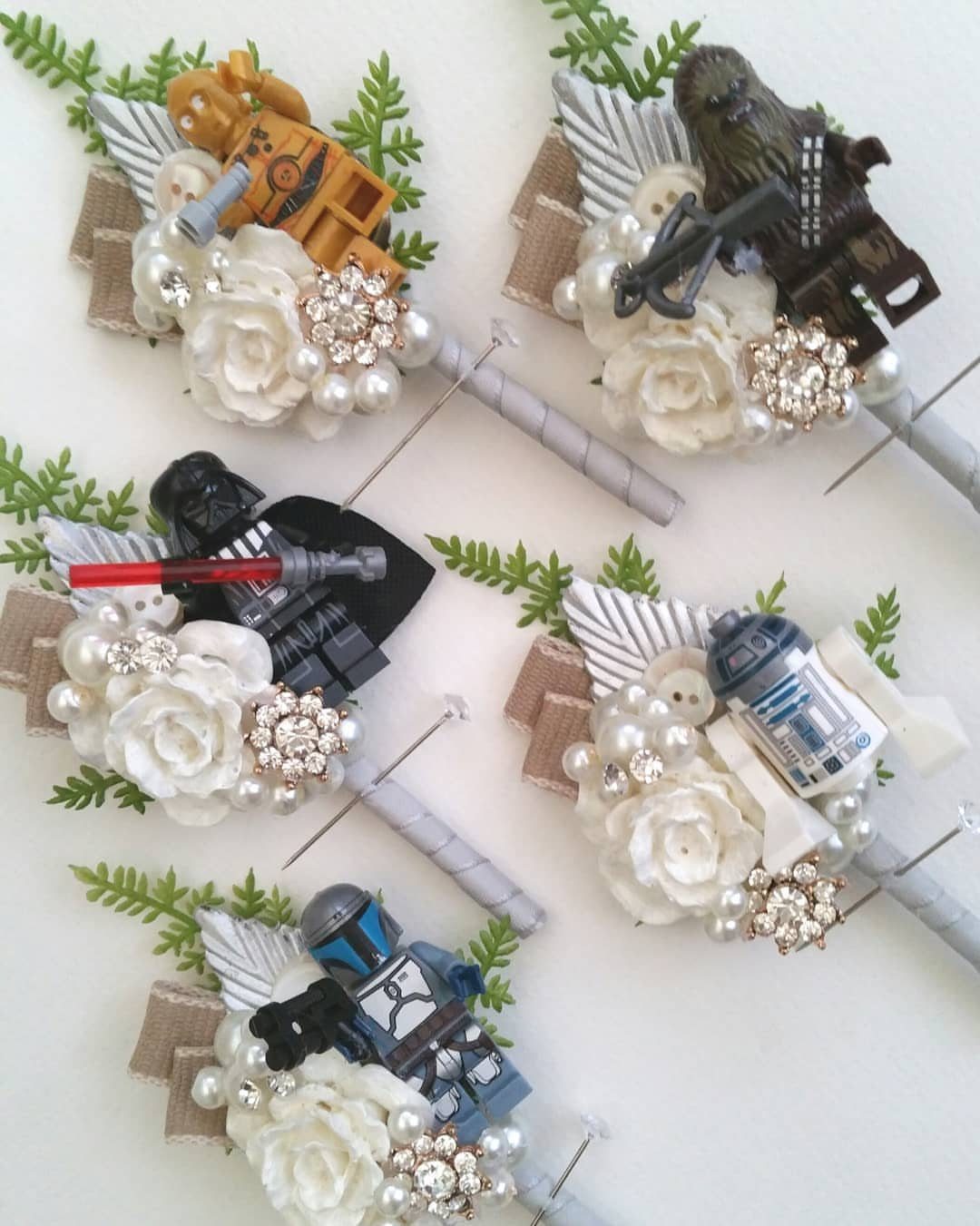 LEGO Star Wars minifigures attached to white floral boutonnieres with pearls and rhinestones.