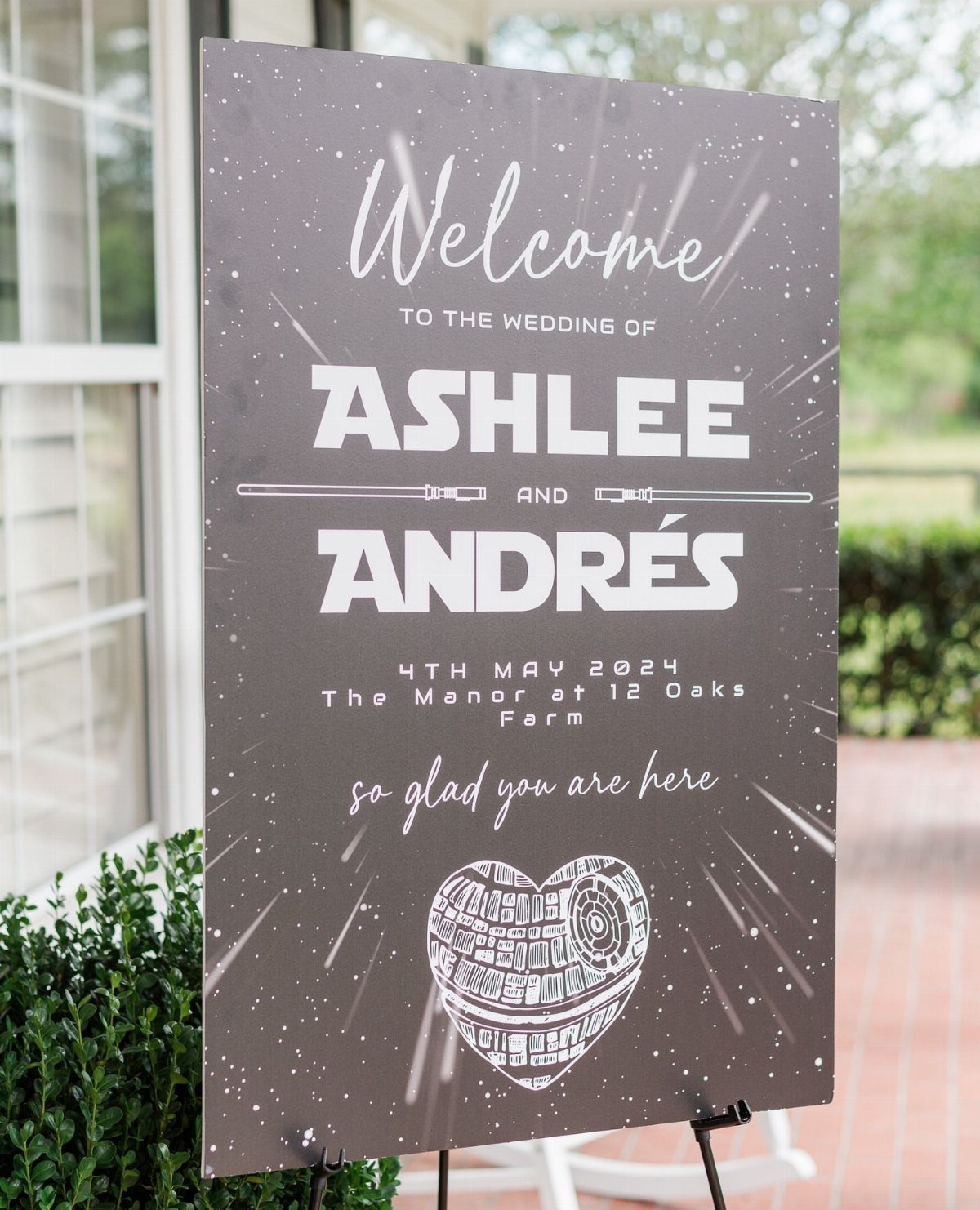 Star Wars themed wedding welcome sign with lightsabers and a heart-shaped Death Star.