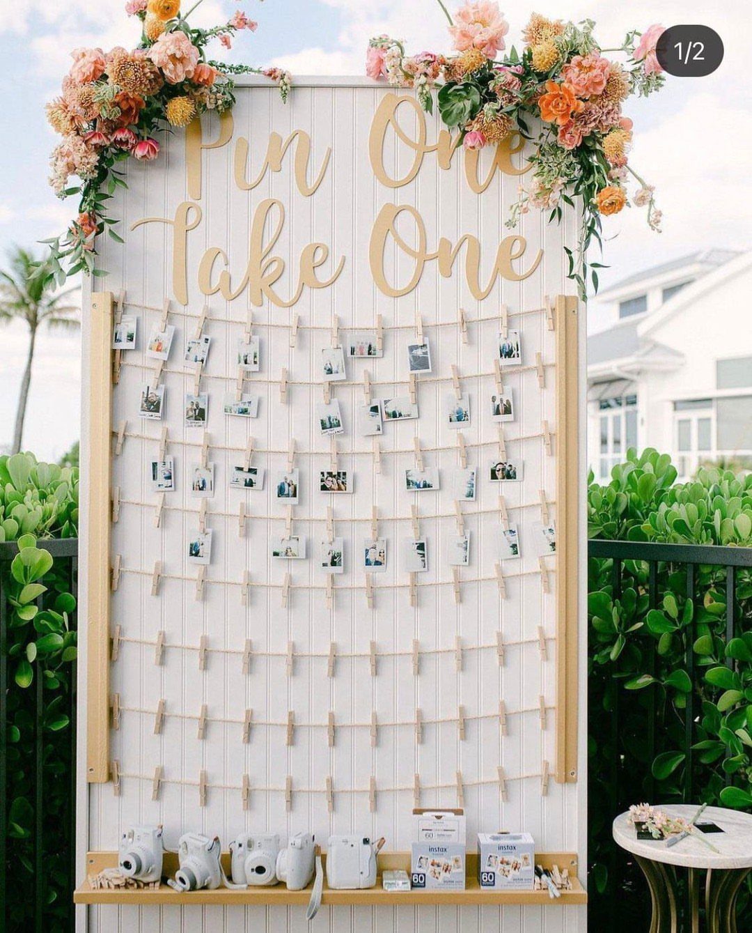 16 Tent Wedding Ideas for Lighting, Tables and Cozy Corners 16 Photo booth wall with polaroid pictures, gold lettering, and instant cameras on a shelf.