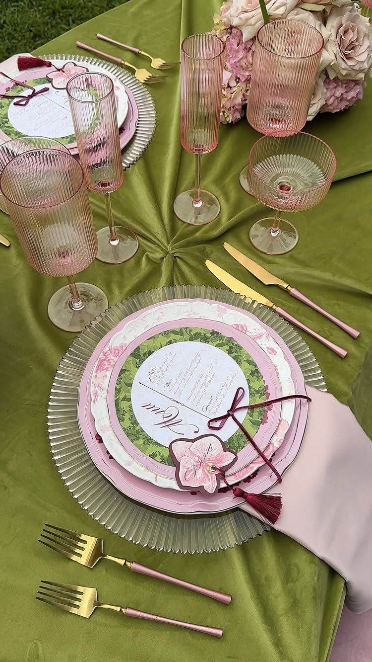 9 Uncommon Wedding Colors for Couples Who Skip the Usual 6 Green tablecloth with pink glassware and gold cutlery for a wedding table setting.