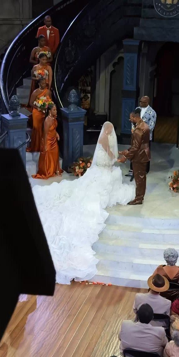Bride and groom standing before a wedding party with an uneven number of attendants.