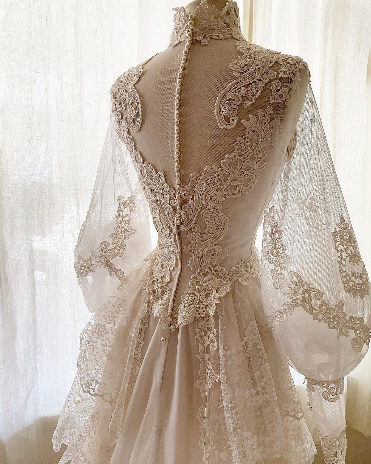 9 Ideas for a Vintage Basque Waist Wedding Dress 6 Vintage white lace wedding dress with a basque waist and puff sleeves on mannequin