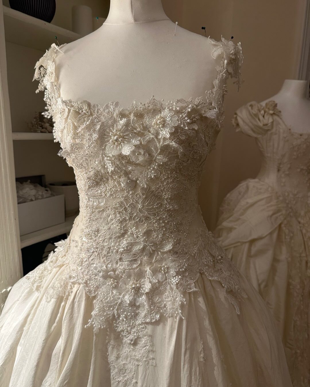 9 Ideas for a Vintage Basque Waist Wedding Dress 3 Ivory wedding dress on a mannequin with intricate lace and beaded floral bodice.