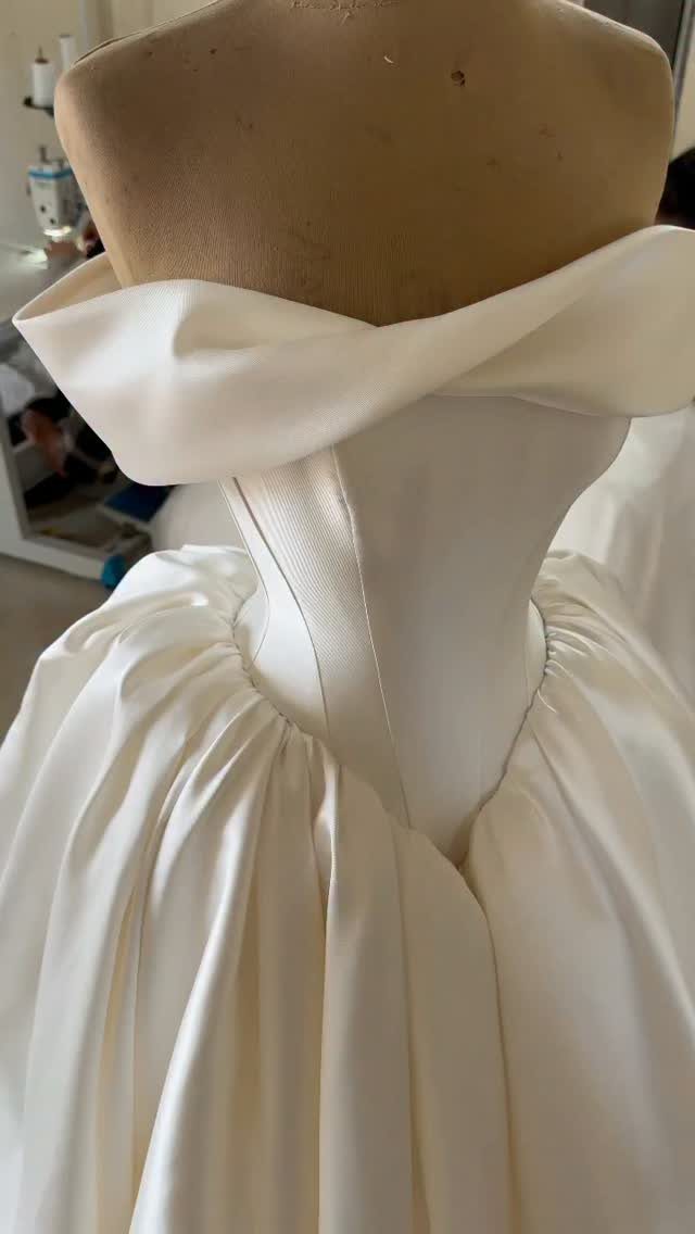 9 Ideas for a Vintage Basque Waist Wedding Dress 7 White satin wedding dress on a mannequin with a structured basque waist bodice.