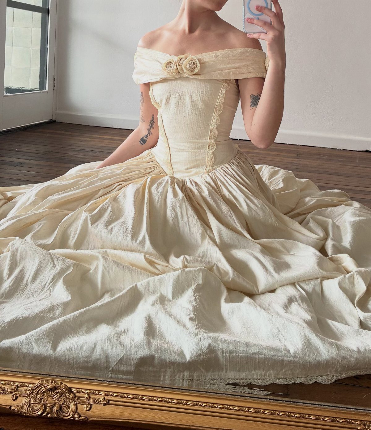 9 Ideas for a Vintage Basque Waist Wedding Dress 5 Cream-colored off-the-shoulder gown with a structured basque waist and full voluminous skirt.