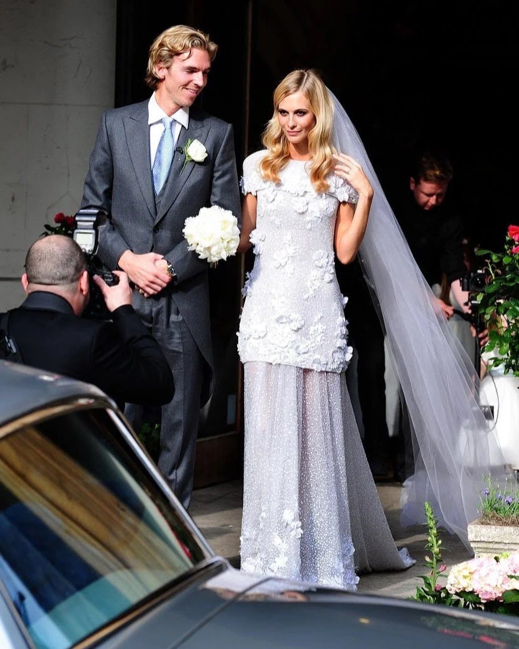 Vintage Chanel Wedding Dress Ideas: 8 Bridal Looks 2 Poppy Delevingne in a beaded white wedding dress with floral details and a veil.