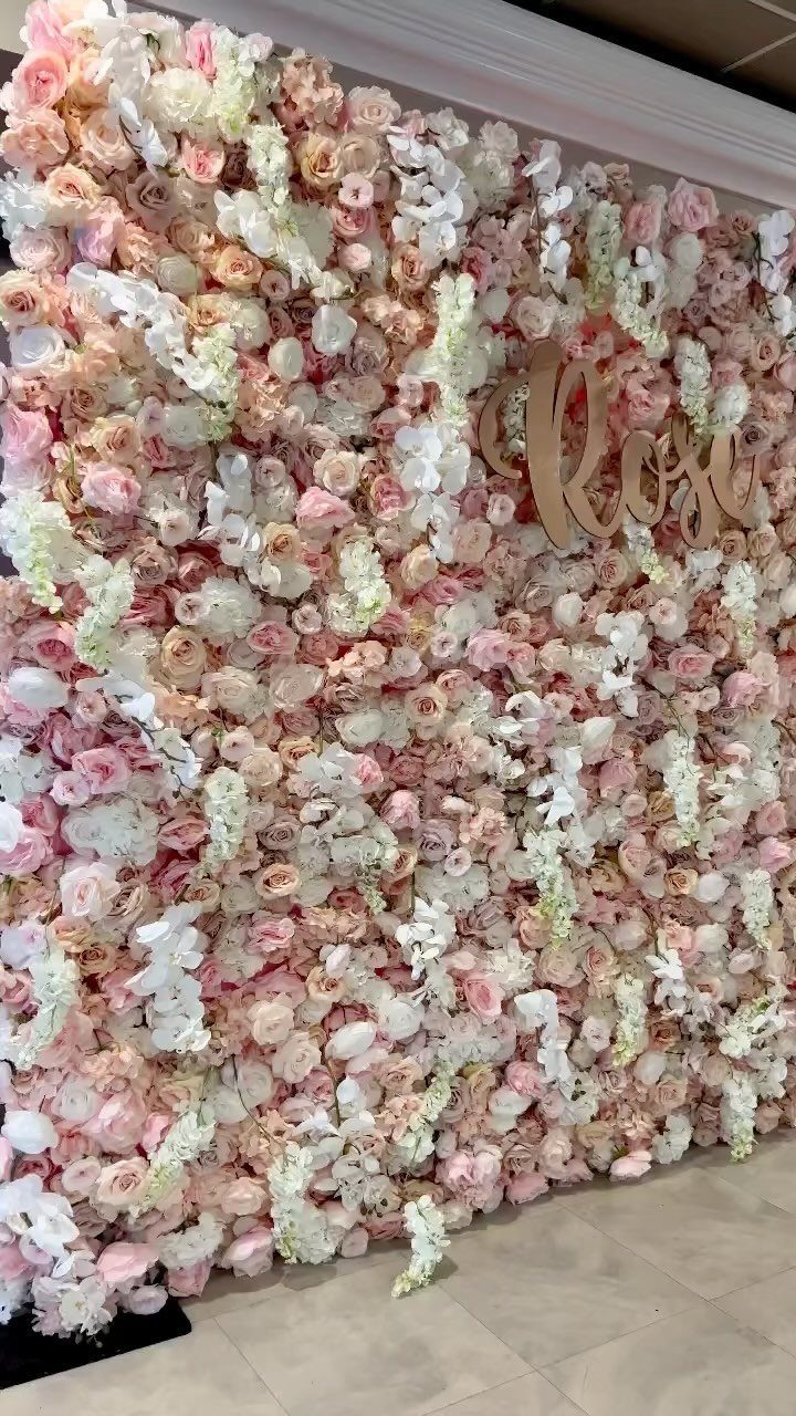 19 Wedding Backdrop Decorations for Any Ceremony Style 11 Flower wall with pink and white roses and a gold cursive sign