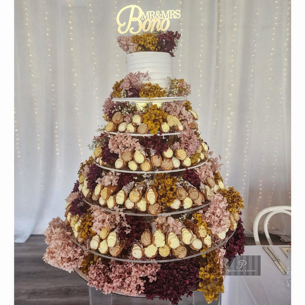 Wedding Cake Photo Ideas: 6 Designs for Every Style 4 Tiered wedding cake and cupcake tower decorated with colorful autumn-toned flowers.